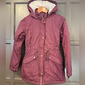 Magenta coat with sherpa lined hood. Missing fur zip off on hood.